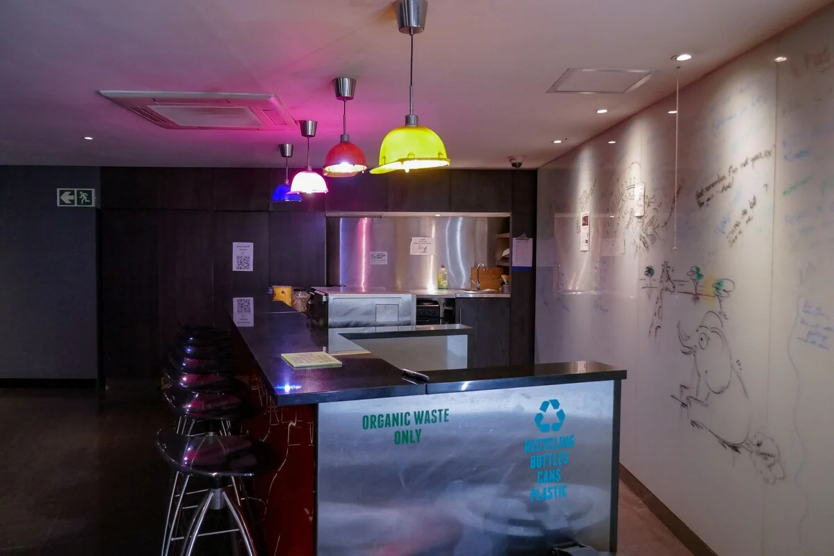 Social kitchen and bar area with colourful hanging lights